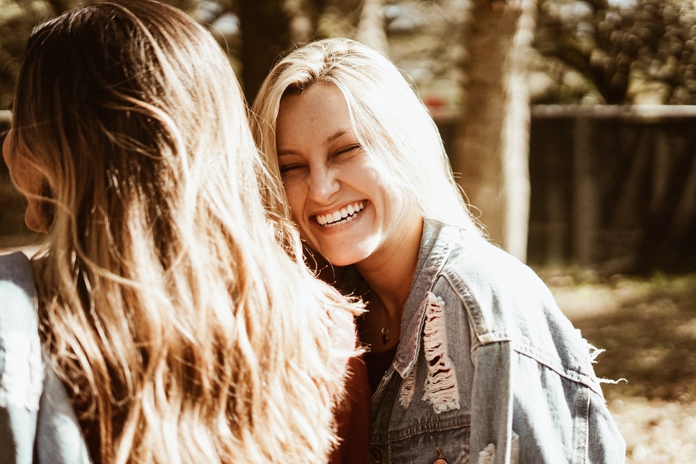 smiling girl wearing blue denim jacket outdoor