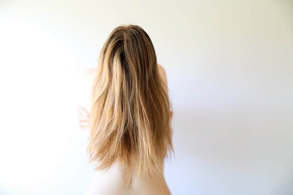 woman with blonde hair looking at the camera